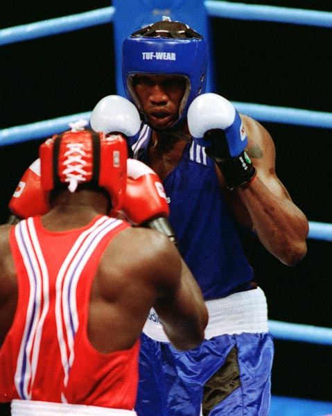 Canada's David Defiagborn (blue)  in action boxing against his opponent at the 1996 Atlanta Summer Olympic Games. (CP PHOTO/COA/Scott Grant)