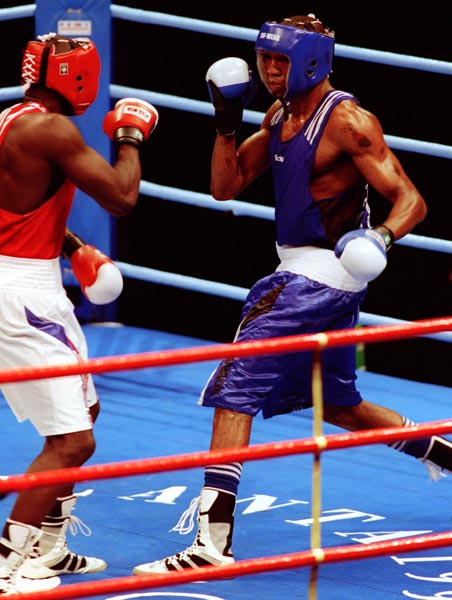 Canada's David Defiagborn (blue) in action boxing against his opponent at the 1996 Atlanta Summer Olympic Games. (CP PHOTO/COA/Scott Grant)