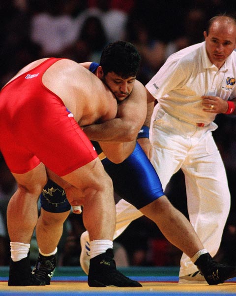Canada's Andy Borodow (blue) competing in the wrestling event at the 1996 Atlanta Summer Olympic Games. (CP PHOTO/COA/Scott Grant)
