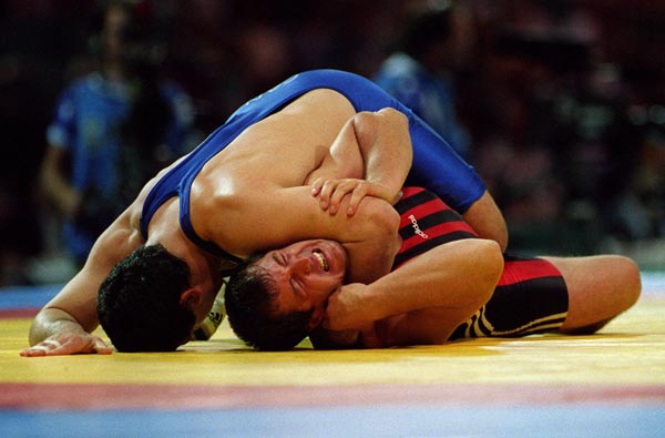 Canada's Oleg Ladik (top) competing in the wrestling event at the 1996 Atlanta Summer Olympic Games. (CP PHOTO/COA/Claus Andersen)