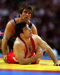 Canada's Oleg Ladik (blue) competes in the wrestling event at the 1996 Atlanta Olympic Games. (CP Photo/COA/Mike Ridewood)