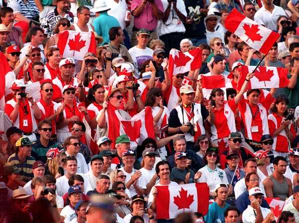 Canada's supporters wave their flags from the crowd at the 1996 Atlanta Summer Olympic Games. (CP PHOTO/COA/Claus Andersen)