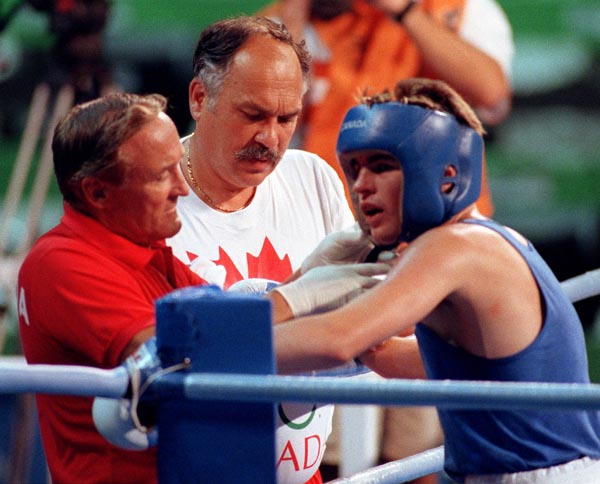 Canada's Mike Strange (right) Adrian Teodorescu (centre) and Taylor Gordon (left) during the boxing event at the 1992 Olympic games in Barcelona. (CP PHOTO/ COA/ F.S.Grant)