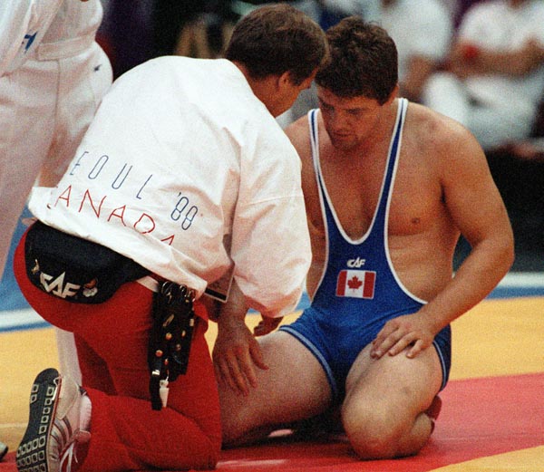 Canada's Doug Cox (blue) and his coach Victor Zilberman competing in the wrestling event at the 1988 Olympic games in Seoul. (CP PHOTO/ COA/ Cromby McNeil)