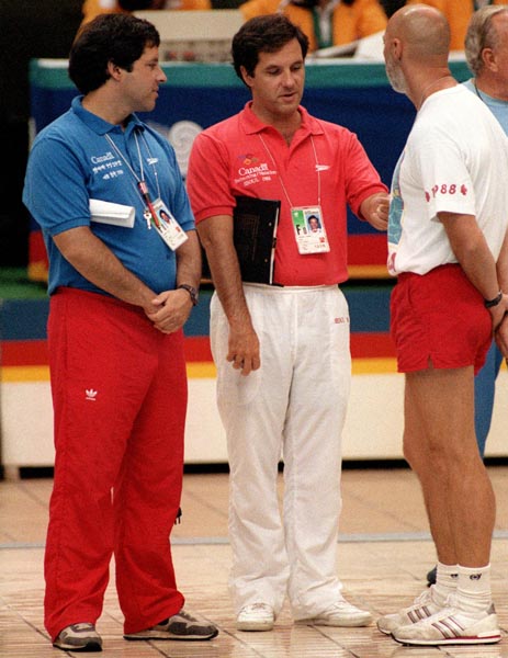 Canada's swim team coaches (from left) Dave Johnson, Tom Johnson and Clifford Barry confer  at the swimming event at the 1988 Olympic games in Seoul. (CP PHOTO/ COA/ Cromby McNeil)