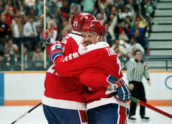 Canada's Randy Gregg (#21) and Steven Tambellini celebrate in hockey action at the 1988 Winter Olympics in Calgary. (CP PHOTO/COA/S.Grant)