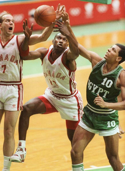 Canada's Karl Tilleman (left) and Dwight Walton (centre) competing in the basketball event at the 1988 Olympic games in Seoul. (CP PHOTO/ COA/ S. Grant)