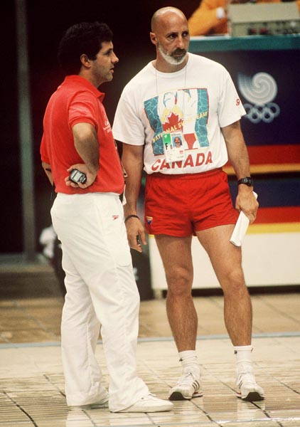 Canadian swim team coaches Dave Johnson (left) and Clifford Barry during the swimming event at the 1988 Olympic games in Seoul. (CP PHOTO/ COA/ Cromby McNeil)