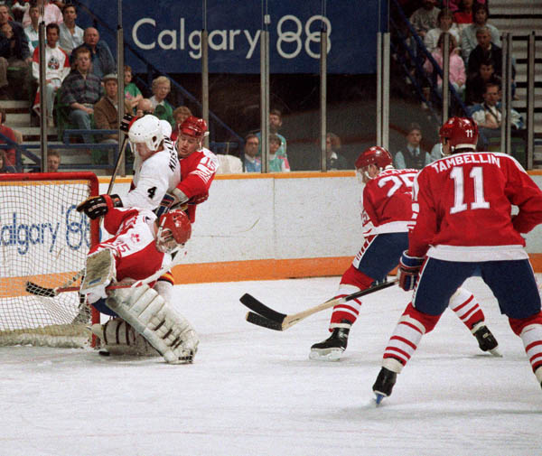 Canada's Andy Moog (#35), Zarley Zalapski (#25), Robert Joyce (#15) and Steven Tambellini (#11)  participate in the hockey event at the 1988 Winter Olympics in Calgary. (CP PHOTO/COA/S.Grant)