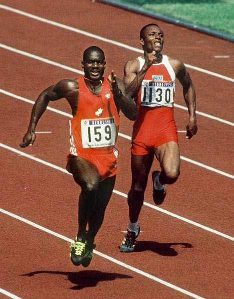 Canada's Ben Johnson (left) and Calvin Smith of the U.S.A. compete in the 100m event at the 1988 Olympic games in Seoul. (CP PHOTO/ COA/ Cromby McNeil)