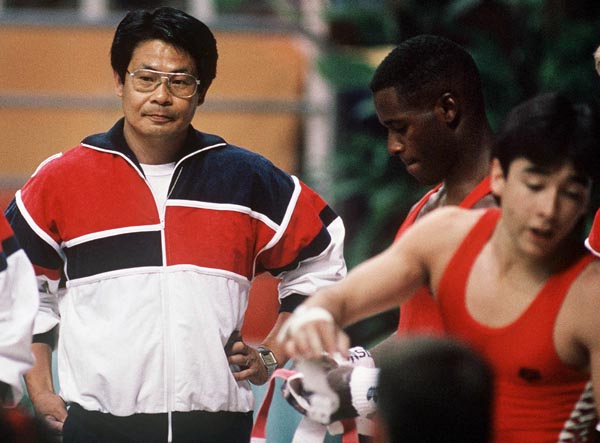 Canada's men's  gymnastics Coach Masaaki Naosaki (left) participates at the 1988 Olympic games in Seoul. (CP PHOTO/ COA/ Tim O'lett)