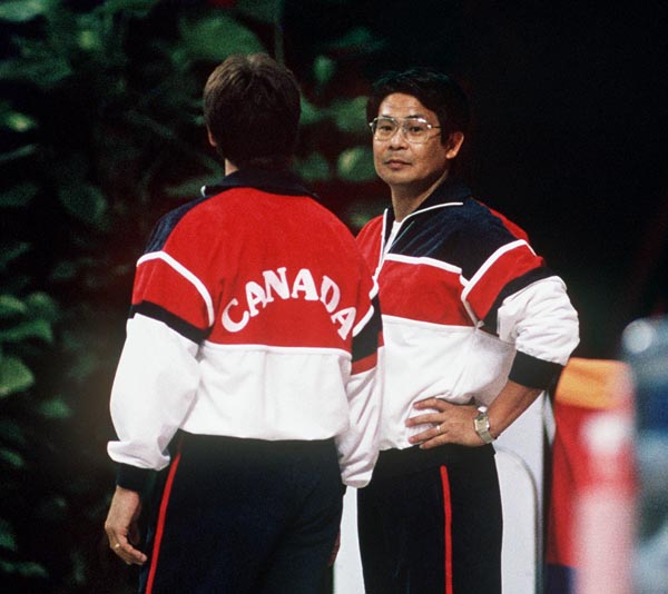 Canada's Masaaki Naosaki (right), coach for the men's gymnastics team, participates at the 1988 Olympic games in Seoul. (CP PHOTO/ COA/ Tim O'lett)