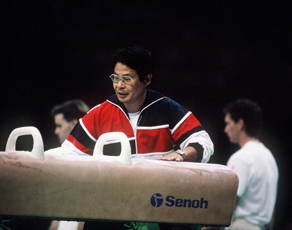 Canada's Masaaki Naosaki (right), coach for the men's gymnastics team, participates at the 1988 Olympic games in Seoul. (CP PHOTO/ COA/ Tim O'lett)