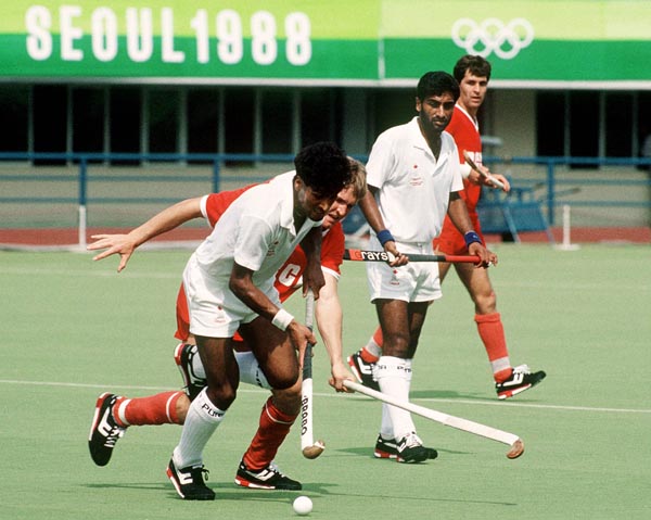 Canada's Satinder Chohan (foreground) and Hargurnek Sandho (centre) play field hockey at the 1988 Seoul Olympic Games. (CP Photo/ COA/ T. Grant)