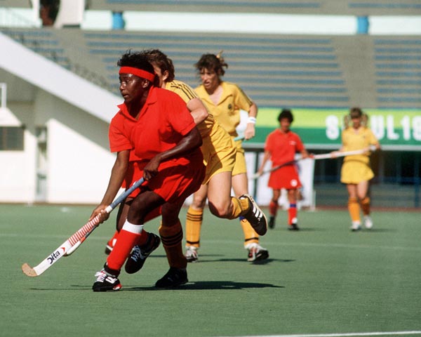 Canada's Sandra Levy (red) plays field hockey at the 1988 Seoul Olympic Games. (CP Photo/ COA/ T. Grant)
