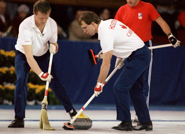 Canada's John Ferguson (left) and Neil Houston compete in the curling event at the 1988 Calgary Olympic winter Games. (CP PHOTO/COA/Ted Grant)