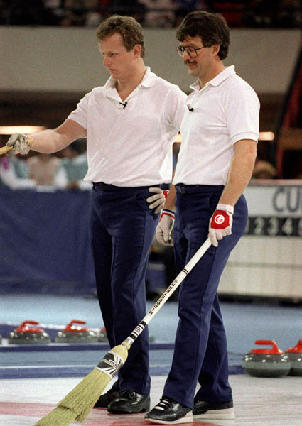Canada's John Ferguson (left) and Edward Lukowich compete in the curling event at the 1988 Calgary Olympic winter Games. (CP PHOTO/COA/Ted Grant)