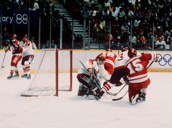 Canada's Sean Burke (goalie), Serge Roy (#3) and Trent Yawney (#5) participate in the hockey event at the 1988 Winter Olympics in Calgary. (CP PHOTO/ COA/ S.Grant)