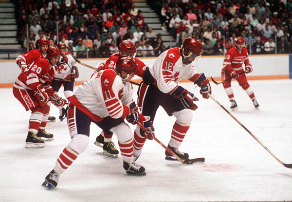 Canada's Steven Tambellini (#11) and Claude Vilgrain (#18) participate in the hockey event at the 1988 Winter Olympics in Calgary. (CP PHOTO/ COA/ S.Grant)