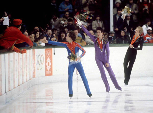 USA's Scott Hamilton (left) and Brian Orser (centre) celebrate after winning the gold and silver medals in the figure skating event at the 1984 Sarajevo Winter Olympic Games.(CP Photo/ COA/ Crombie McNeil)