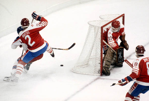 Canada's Robin Bartel (2), Mario Gosselin (goalie) and David Tippett (8) compete in hockey action against the United States at the 1984 Winter Olympics in Sarajevo. (CP PHOTO/ COA/O. Bierwagon )