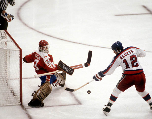 Canada's Mario Gosselin (goalie) stops a shot from Edward Olczyk of the United States during hockey action at the 1984 Winter Olympics in Sarajevo. (CP PHOTO/ COA/O. Bierwagon )