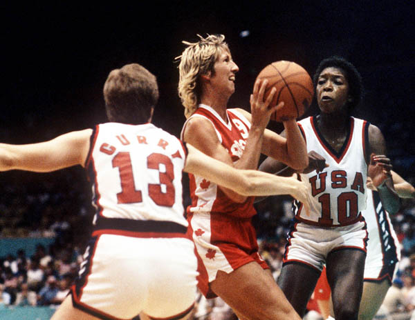 Canada's Alison Lang (centre) drives through Team USA players during women's basketball action at the 1984 Olympic Games in Los Angeles. (CP PHOTO/COA/JM)