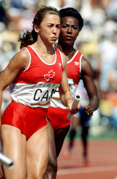Canada's  France Gareau (left) and Angella Taylor exchange the baton during an athletics event at the 1984 Olympic games in Los Angeles. (CP PHOTO/ COA/JM)
