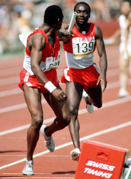 Canada's Tim Bethune (left) and Bryan Saunders exchange the baton during a relay event at the 1984 Olympic games in Los Angeles. (CP PHOTO/ COA/JM)