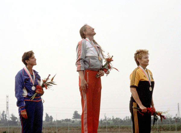 Canada's Linda Thom (centre) celebrates a gold medal win in a shooting event at the 1984 Olympic games in Los Angeles. (CP PHOTO/ COA/ Tim O'lett)