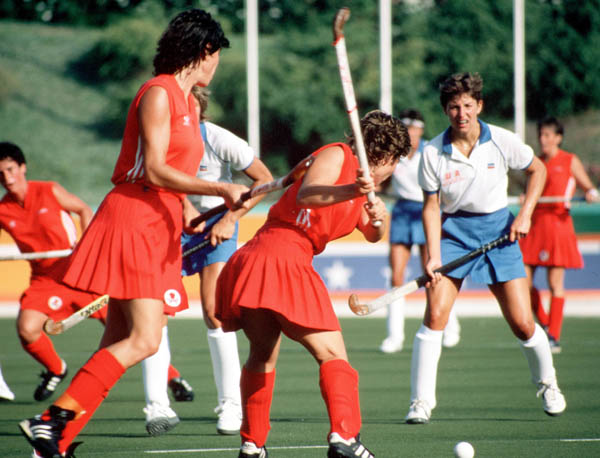 Canada's Shelly Andrews and Laurie Lambert (red) play field hockey at the 1984 Los Angeles Olympic Games. (CP Photo/ COA/ Ted Grant)