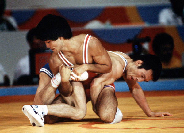 Canada's Ray Takahashi (red) competes in the freestyle wrestling event at the 1984 Olympic games in Los Angeles. (CP PHOTO/COA/Crombie McNeil)