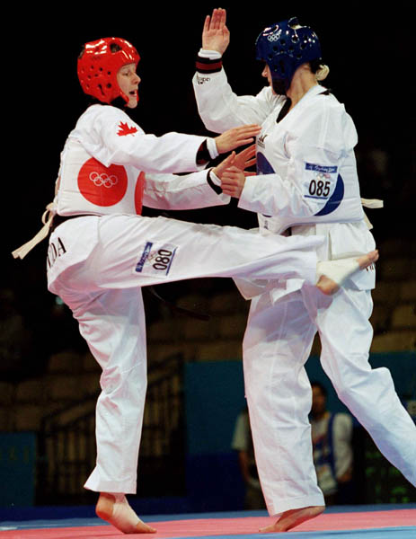Canada's Dominique Bosshart (left) competes in the taekwondo event of the Sydney 2000 Olympic Games(CP PHOTO/ COA)