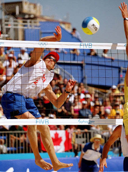 Canada's Conrad Leinemann smashes the ball during beach volleyball action at the 2000 Sydney Olympic Games on September 22, 2000. (CP Photo/ COA)
