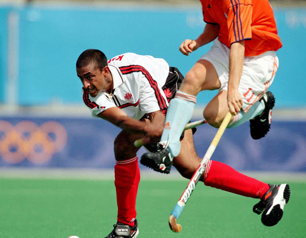 Canada's Ravi Kahlon (left) participates in field hockey action at the 2000 Sydney Olympic Games. (CP Photo/ COA)
