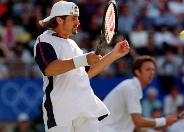 Canada's Sebastian Lareau (foreground) and Daniel Nestor compete in tennis doubles at the 2000 Sydney Olympic Games. ( Mike Ridewood/CP Photo/ COA)