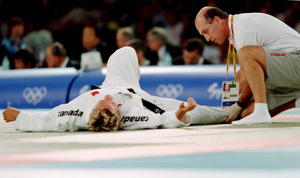 Canada's Kimberley Ribble (left) gets examined during a Judo match at the Sydney 2000 Olympic Games(CP PHOTO/ COA)