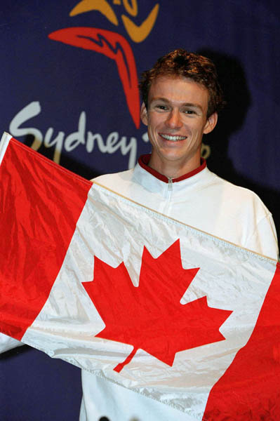 Canada's gold medalist in the triathlon Simon Whitfield, of Kingston, Ont., is announced as the flag bearer at the Olympic Games during a press conference in Sydney, Sunday, Oct. 1, 2000. (CP PHOTO/Mike Ridewood)