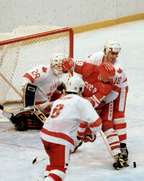 Canada's Paul Pageau (goalie), Don Spring (8) and Dan D'Alvise (18) compete in hockey action against the U.S.S.R. at the 1980 Winter Olympics in Lake Placid. (CP Photo/ COA)