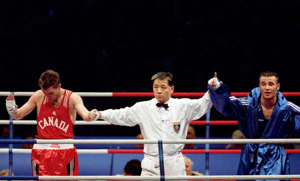 Canada's Mike Strange (left) competes in the boxing event of the 2000 Sydney Olympic Games. (CP Photo/ COA)