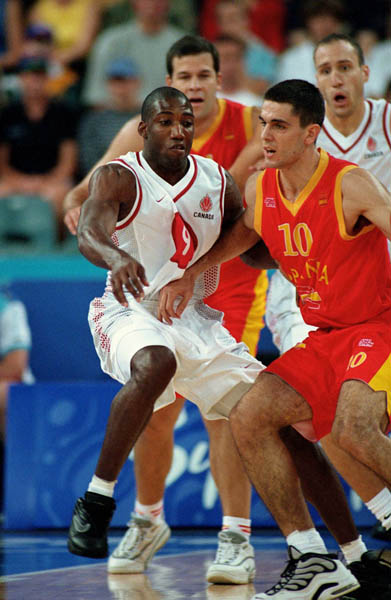Canada's Rowan Barrett (left) participates in basketball action at the 2000 Sydney Olympic Games. (CP Photo/ COA)
