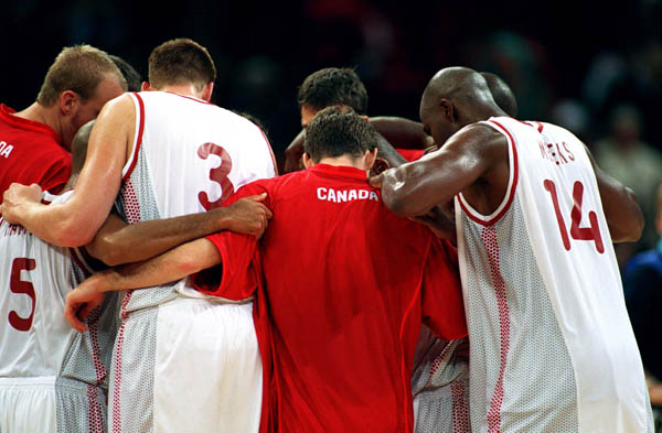 Canada's men's basketball team stands together during basketball action at the 2000 Sydney Olympic Games. (CP Photo/ COA)