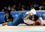 Canada's Nicolas Gill, (bottom) from Montreal, is thrown by Italy's Michele Monti in the -100kg judo competition at the Summer Olympics in Athens Thursday, August 19, 2004. Gill, Canada's flag bearer and medal hopefull, lost the first round match. (CP PHOTO/COC-Mike Ridewood)