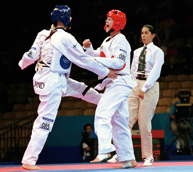 Canada's Dominique Bosshart (right) competes in the Taekwondo event of the 2000 Sydney Olympic Games. (CP PHOTO/ COA)