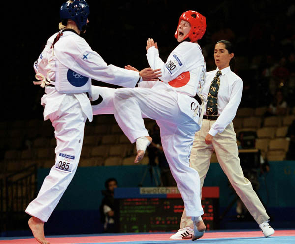 Canada's Dominique Bosshart (right) competes in the Taekwondo event of the 2000 Sydney Olympic Games. (CP PHOTO/ COA)
