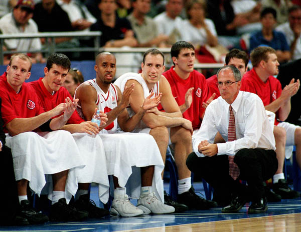 Canada's basketball team and coach Jay Triano keep close watch of the action at the 2000 Sydney Olympic Games. (CP Photo/ COA)