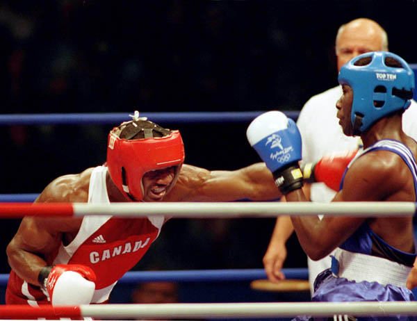 Canada's Troy Amos (left) competes in a boxing match of the 2000 Sydney Olympic Games. (CP Photo/ COA)