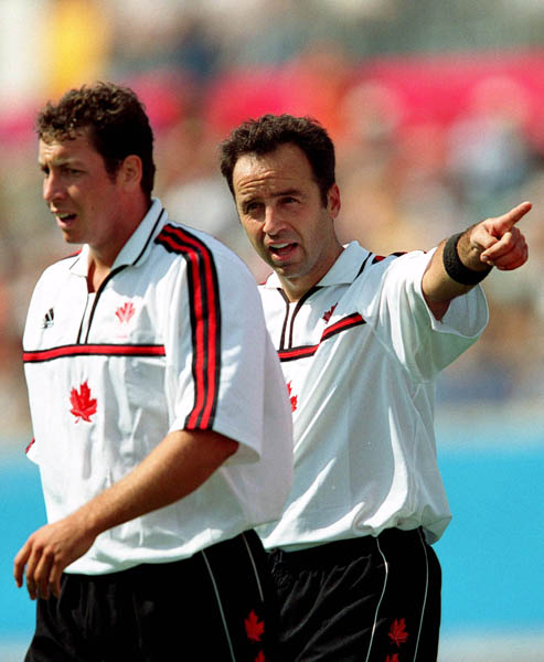 Canada's Scott Mosher (left) and Peter Milkovich exchange words during field hockey action at the 2000 Sydney Olympic Games. (CP Photo/ COA)