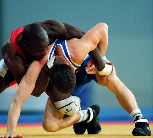 Canada's Daniel Igali (red) competes in the wrestling event at the 2000 Sydney Olympic Games. (CP Photo/ COA)