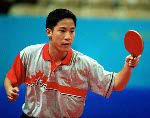 Canada's Johnny Huang of Toronto hits a shot during his loss to Aleksandar Karakasevic of Serbia and Montenegro in men's table tennis at the Summer Olympics in Athens, Greece,  Monday, August 16, 2004.  (CP PHOTO/COC/Mike Ridewood)